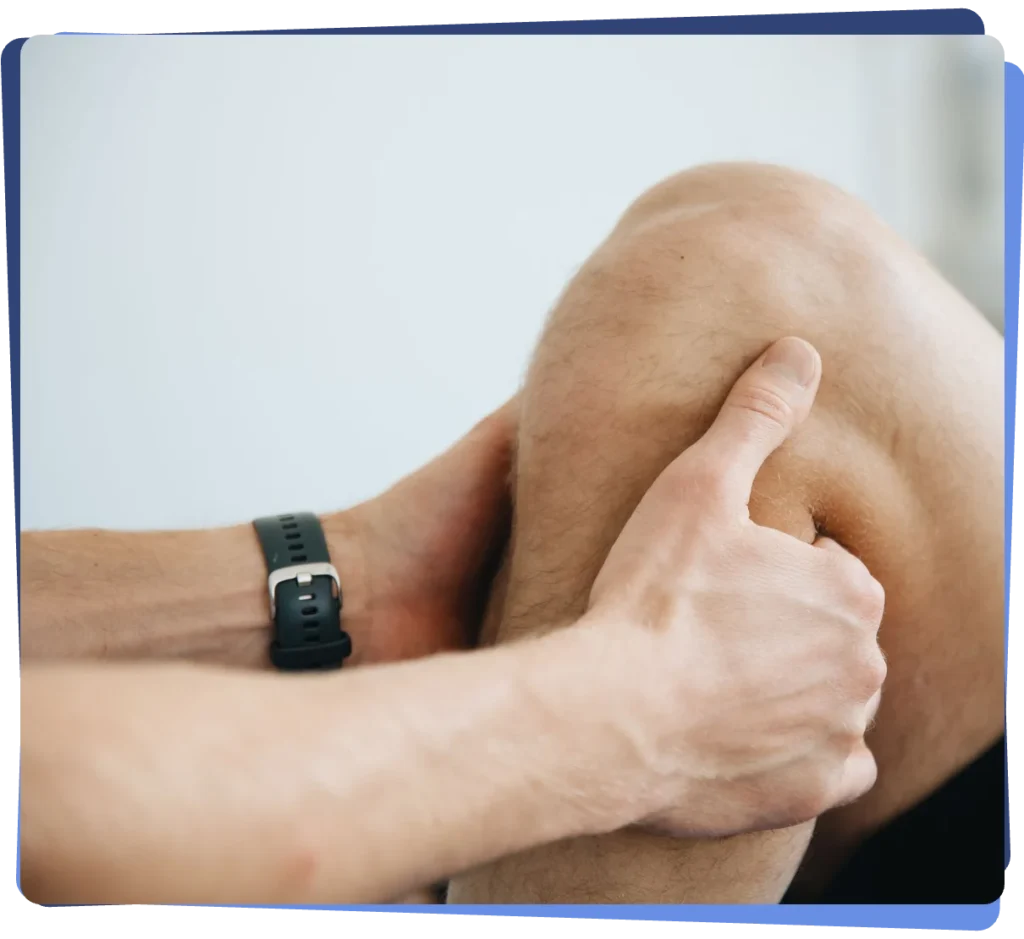 Hands holding a knee, illustrating knee joint pain treated with joint injections